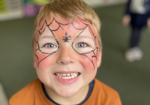 chłopiec z twarzą pomalowaną za człowieka pająka